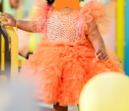 Picture of Orange pearl frock with feather detailing 1y