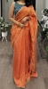 Picture of Orange tissue saree with contrast peacok color blouse